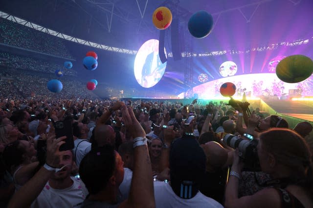 Will Champion of Coldplay performs on stage at Wembley Stadium