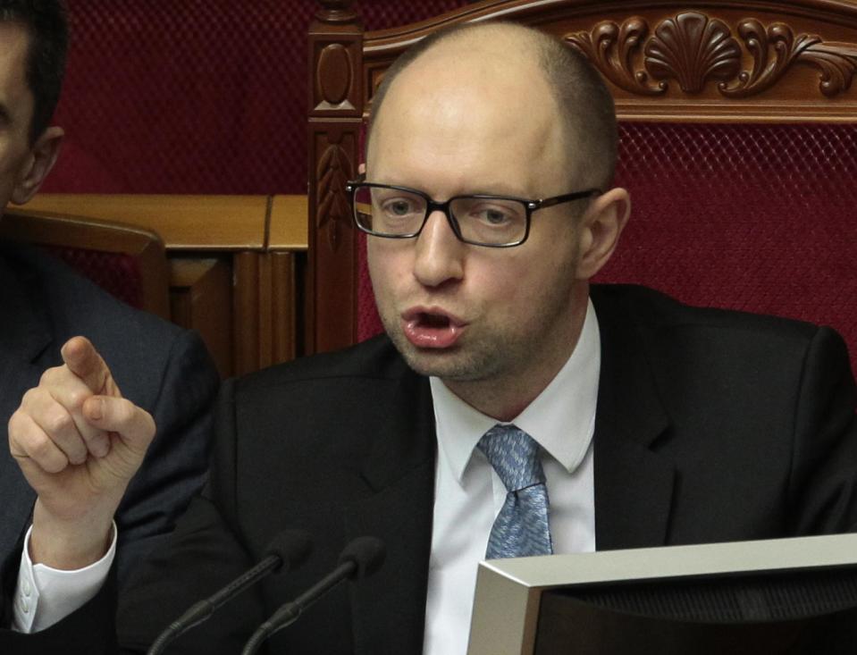 Ukrainian Prime Minister Arseniy Yatsenyuk speaks to lawmakers during a session at the Ukrainian parliament in Kiev, Ukraine, Friday, April 18, 2014. Pro-Russian insurgents in Ukraine's east who have been occupying government buildings in more than 10 cities said Friday they will only leave them if the interim government in Kiev resigns. (AP Photo/Sergei Chuzavkov)