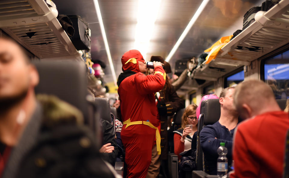 COLOGNE, GERMANY - FEBRUARY 04:   A man wears 'the flash' costume as carnival revellers celebrate in a Train to Cologne during Weiberfastnacht celebrations as part of the carnival season on February 4, 2016 in Cologne, Germany. Carnival partying and parades, a centuries-old tradition in western and southwestern Germany, traditionally goes from today until Ash Wednesday on February 10 and culminates in Rose Monday on February 8. Police are on added alert this year, particularly in Cologne, due to the New Year's Eve sex attacks on women that have been attributed to gangs of North African men, predominantly from Algeria and Morocco. Police have created safe areas and brought in additional lighting for poorly-lit streets.  (Photo by Volker Hartmann/Getty Images)