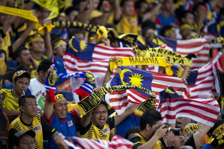 Malaysian fans celebrate victory against Indonesia in their AFF Suzuki Cup Group B match on December 1. Malaysia won the match 2-0 to reach the last four as group runners-up. They face an impressive Thailand at Kuala Lumpur's cacophonous Bukit Jalil stadium on Sunday