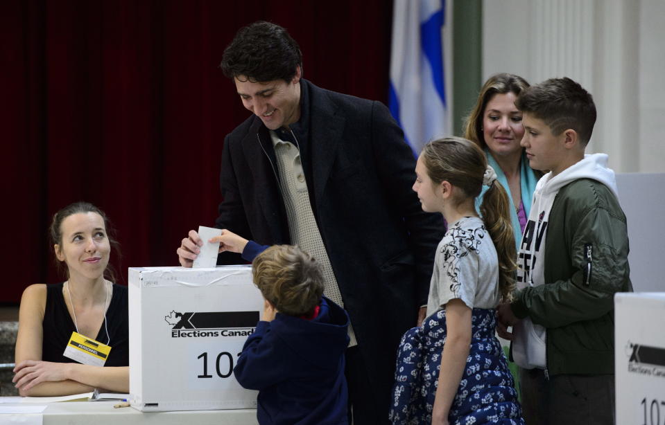 Canadian Prime Minister Justin Trudeau, second from left, votes with wife Sophie Gregoire-Trudeau, and children Xavier, Ella-Grace and Hadrien in Montreal, Monday, Oct. 21, 2019. Trudeau faced the threat of being knocked from power after one term as the nation held parliamentary elections on Monday. (Sean Kilpatrick/The Canadian Press via AP)