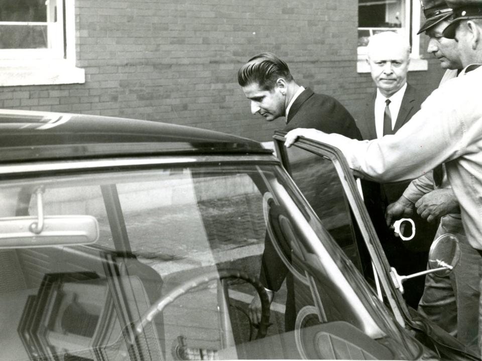 lbert DeSalvo surrounded by police getting into a car in 1967.