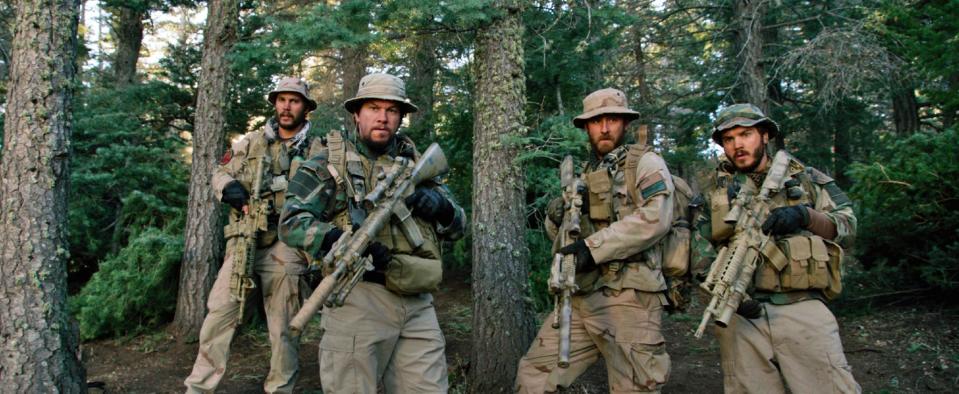 This photo released by Universal Pictures shows, from left, Taylor Kitsch, as Michael Murphy, Mark Wahlberg as Marcus Luttrell, Ben Foster as Matt “Axe” Axelson, and Emile Hirsch as Danny Dietz in a scene from the film, “Lone Survivor." In the age of the superhero, the movies' most reliable real-life hero has been the Navy SEAL. "Lone Survivor," is the latest in a string of films, including "Zero Dark Thirty" and "Act of Valor" to honor the Navy's special operations force with as much faithfulness as the filmmakers could muster. (AP Photo/Universal Pictures)