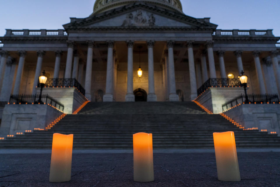 Electric candles await a bipartisan group of members Congress for a moment of silence honoring the 500,000 U.S. COVID-19 deaths, Tuesday, Feb. 23, 2021, by the east front steps of the Capitol in Washington. (AP Photo/Jacquelyn Martin)