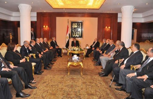 In this handout picture made available by the Egyptian presidency, Egyptian President Mohamed Morsi (C top) meets members of the constitutional high court prior to his swearing-in ceremony at the Constitutional Court in Cairo