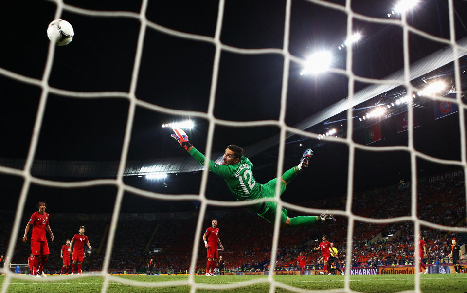 KHARKOV, UKRAINE - JUNE 17: Rui Patricio of Portugal dives as he attempts to make a save during the UEFA EURO 2012 group B match between Portugal and Netherlands at Metalist Stadium on June 17, 2012 in Kharkov, Ukraine. (Photo by Julian Finney/Getty Images)