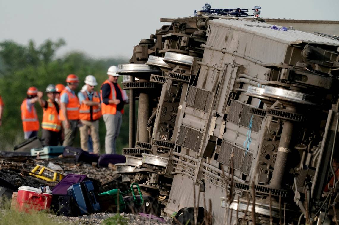 Workers inspected the scene after an Amtrak train derailed after striking a dump truck June 27 near Mendon, Missouri.