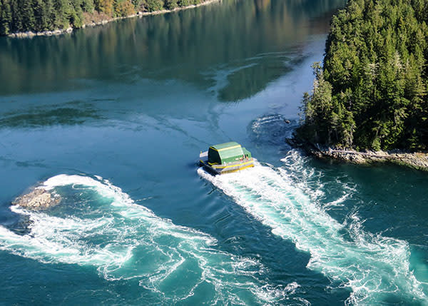  Daily tidal flows buffeted the turbine-equipped private barge at Dent Island but no usable electricity was produced in the experiment. The barge has since been removed. (Dent Island Resort)