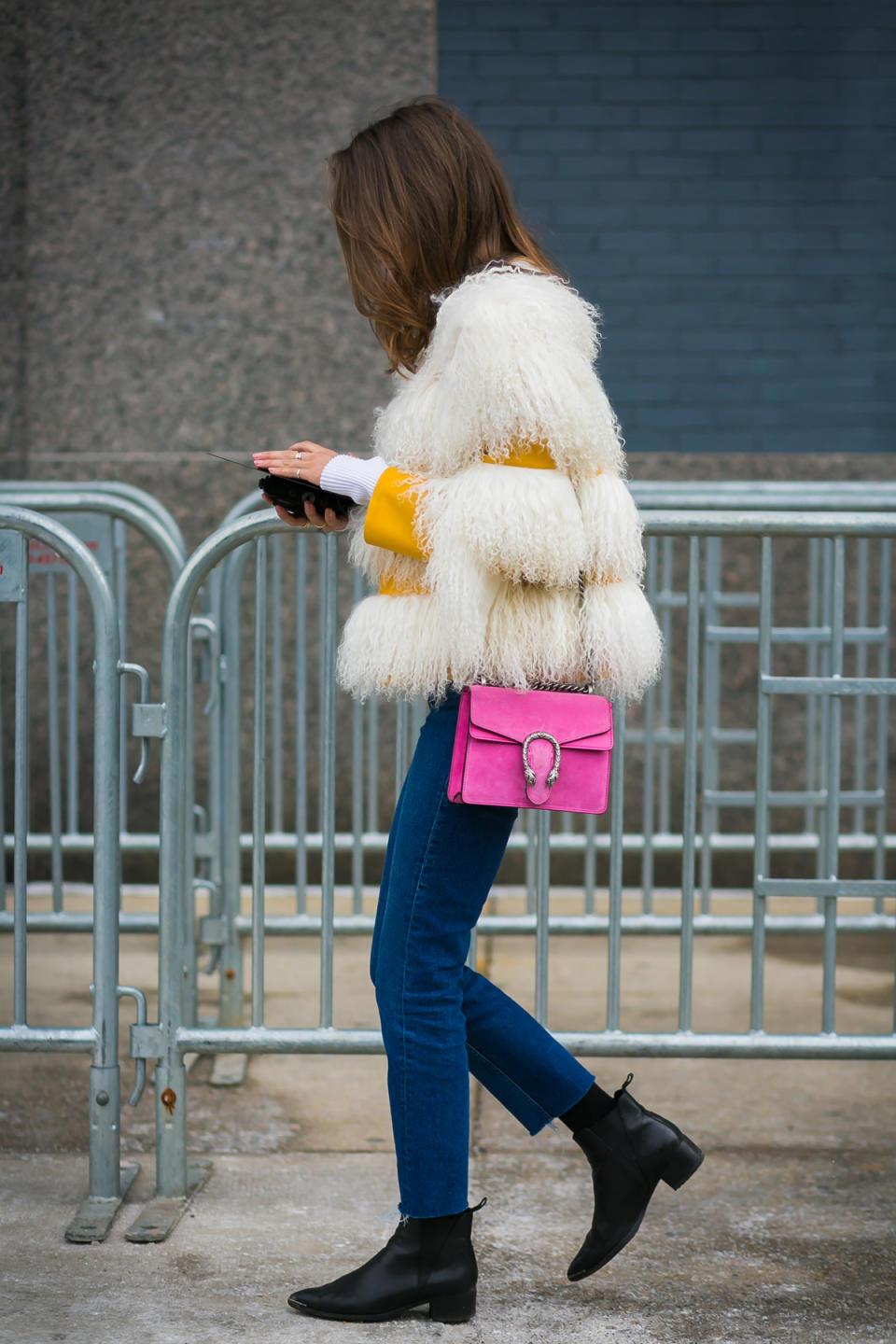 Marina Larroude in a shaggy coat and Gucci bag at New York Fashion Week.