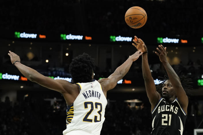 Milwaukee Bucks' Jrue Holiday (21) shoots against Indiana Pacers' Aaron Nesmith (23) during the second half of an NBA basketball game, Monday, Jan. 16, 2023, in Milwaukee. (AP Photo/Aaron Gash)