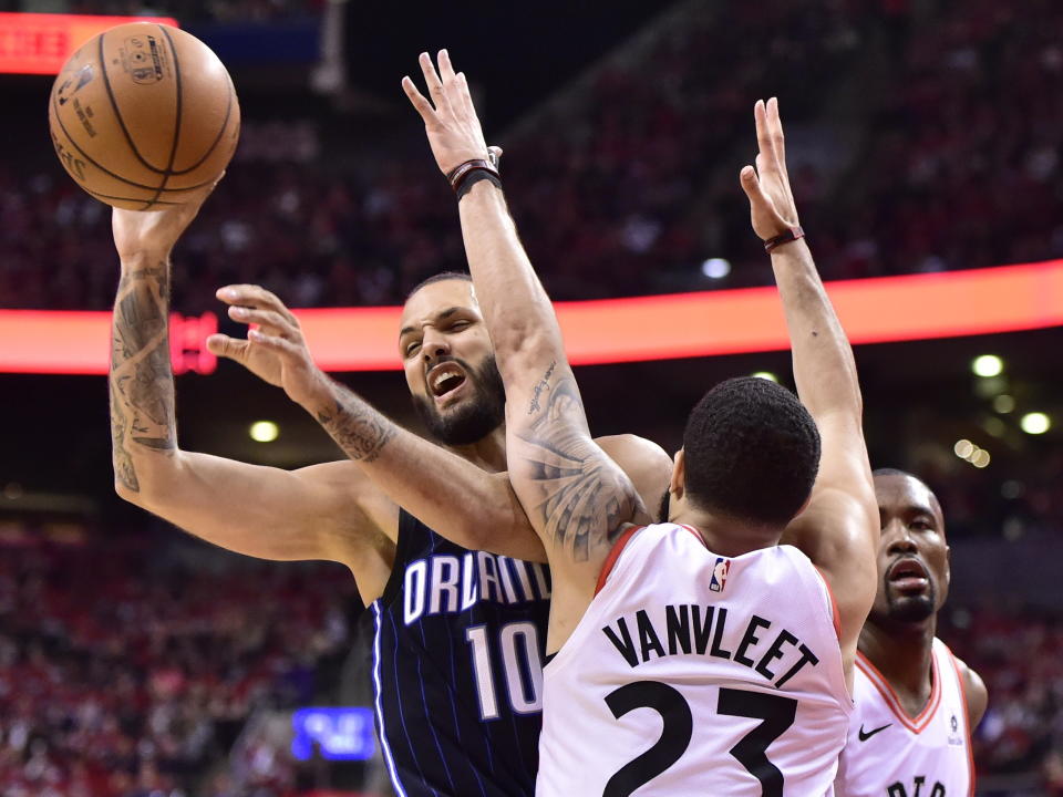 Orlando Magic guard Evan Fournier (10) controls the ball as Toronto Raptors guard Fred VanVleet (23) defends during the second half in Game 1 of a first-round NBA basketball playoff series in Toronto, Saturday, April 13, 2019. (Frank Gunn/The Canadian Press via AP)