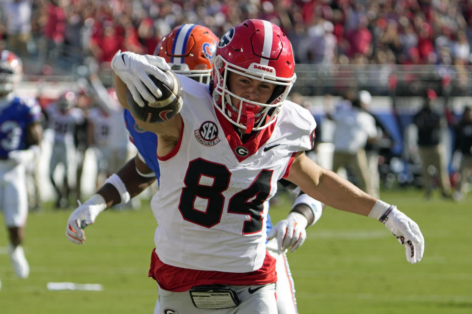 Georgia wide receiver Ladd McConkey (84) crosses the goal line in front of Florida linebacker Scooby Williams to score a touchdown on a 41-yard pass play during the first half of an NCAA college football game, Saturday, Oct. 28, 2023, in Jacksonville, Fla. (AP Photo/John Raoux)