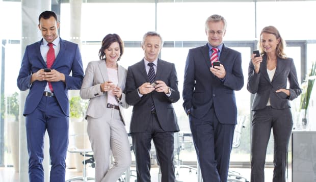 Business partners texting on their phones