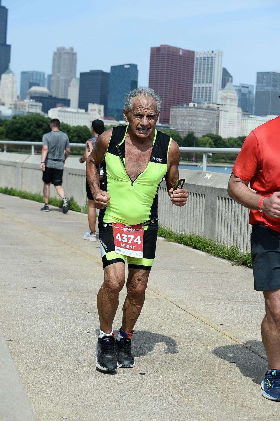 Dr. Joseph Maroon running outdoors during a triathlon.