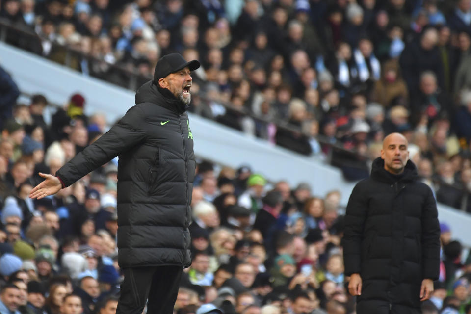 Liverpool's manager Jurgen Klopp, left, reacts during the English Premier League soccer match between Manchester City and Liverpool at Etihad stadium in Manchester, England, Saturday, Nov. 25, 2023. (AP Photo/Rui Vieira)