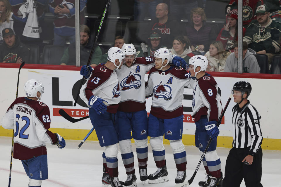 Colorado Avalanche right wing Valeri Nichushkin (13) celebrates with teammates after scoring a goal against the Minnesota Wild during the third period of an NHL hockey game Monday, Oct. 17, 2022, in St. Paul, Minn. (AP Photo/Stacy Bengs)