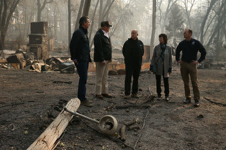 U.S. President Donald Trump visits the charred wreckage of Skyway Villa Mobile Home and RV Park with Governor-elect Gavin Newsom (L), FEMA head Brock Long (R), Paradise Mayor Jody Jones (2nd R) and Governor Jerry Brown in Paradise, California, U.S., November 17, 2018. REUTERS/Leah Millis