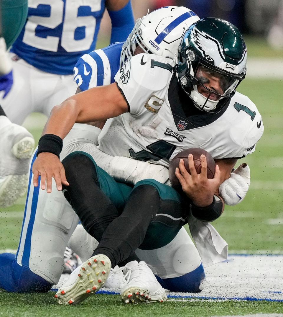 Indianapolis Colts defensive tackle Chris Williams (95) brings down Philadelphia Eagles quarterback Jalen Hurts (1) on Sunday, Nov. 20, 2022, during a game against the Philadelphia Eagles at Lucas Oil Stadium in Indianapolis.