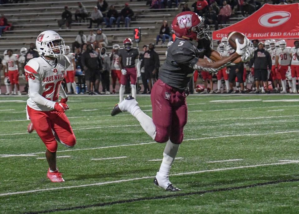 Westside High receiver Josh Williams (5) catches a pass near Greenville's Jayden Blandin (20)  for a touchdown during the first quarter at Westside High in Anderson, S.C. Monday, October 3, 2022.