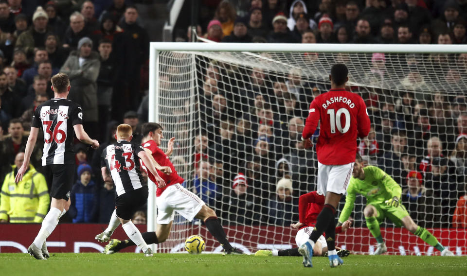 Newcastle United's Matthew Longstaff, second left, scores his side's first goal of the game during their English Premier League soccer match against Manchester United at Old Trafford, Manchester, England, Thursday, Dec. 26, 2019. (Martin Rickett/PA via AP)