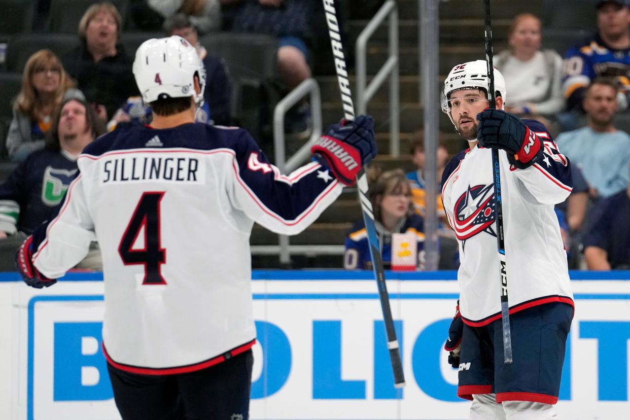Columbus Blue Jackets' Emil Bemstrom (52) is congratulated by Cole Sillinger (4) after scoring during the third period of a preseason NHL hockey game against the St. Louis Blues Tuesday, Sept. 26, 2023, in St. Louis. (AP Photo/Jeff Roberson)