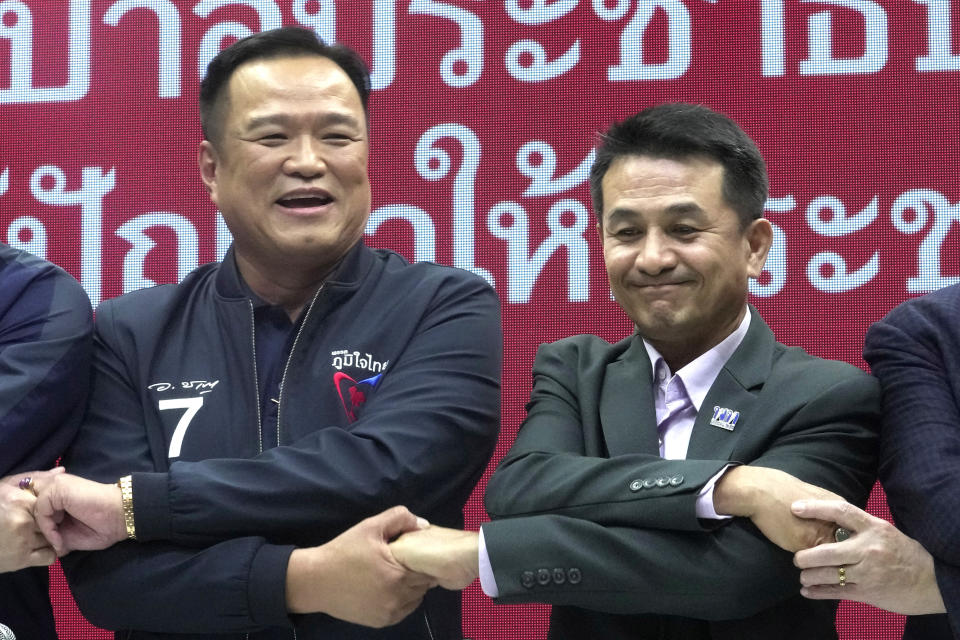 Leader of Bhumjaithai Party Anutin Charnvirakul, left, shake hand with Leader of Pheu Thai party Chonlanan Srikaew smile during a press conference announcing a coalition party Thai Party headquarters in Bangkok, Thailand, Monday, Aug. 7, 2023. The populist Pheu Thai Party on Monday announced it will assemble a coalition with the Bhumjaithai Party from the outgoing administration to solve the months long political deadlock. (AP Photo/Sakchai Lalit)