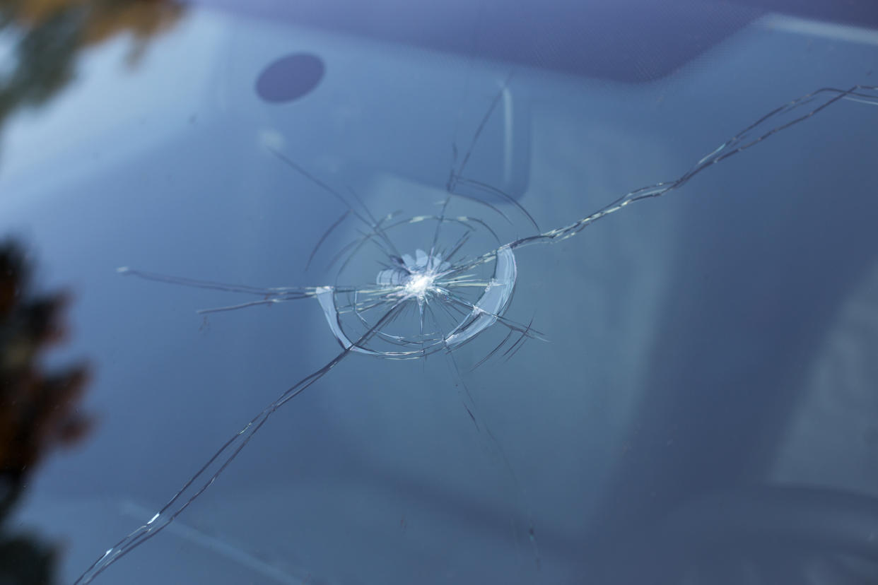 Smashed windscreen of a car, damaged glass, windshield repair kit