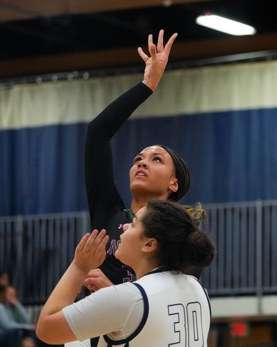 Des Moines North's Amani Jenkins shoots over Des Moines Roosevelt's Jazmyn Guerrero (30) during Friday's game at Roosevelt High School.