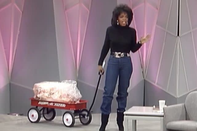 <p>Oprah.com</p> Oprah Winfrey brings out a wagon full of fat to illustrate how much weight she'd lost on an 1988 episode of 'The Oprah Winfrey Show.'