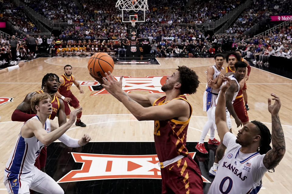 Iowa State guard Gabe Kalscheur gets past Kansas guard Bobby Pettiford Jr. (0) to put up a shot during the first half of an NCAA college basketball game in the semifinal round of the Big 12 Conference tournament Friday, March 10, 2023, in Kansas City, Mo. (AP Photo/Charlie Riedel)