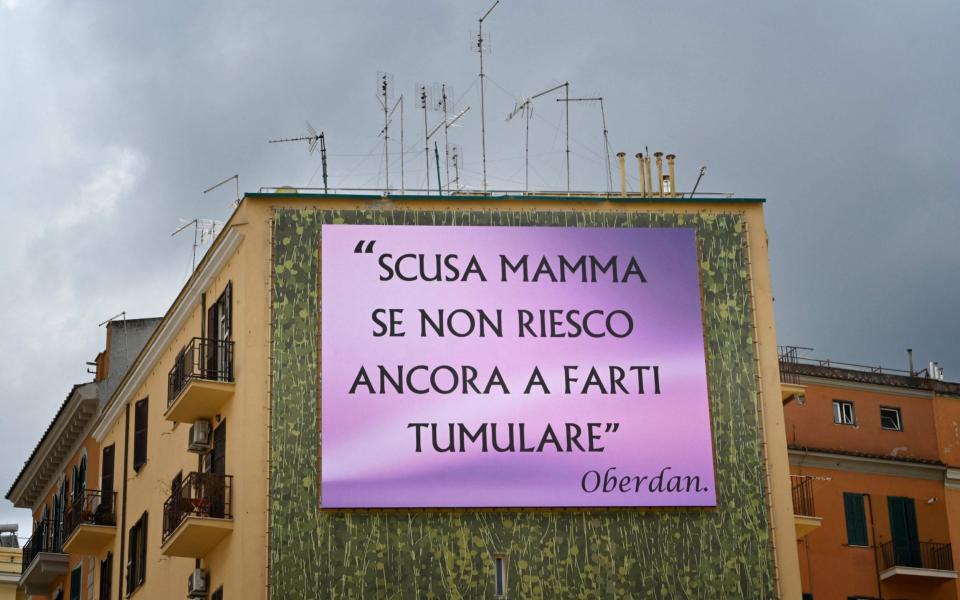 'I'm sorry Mum that I haven't been able to have you buried' say the giant billboards that have appeared in Rome - AFP