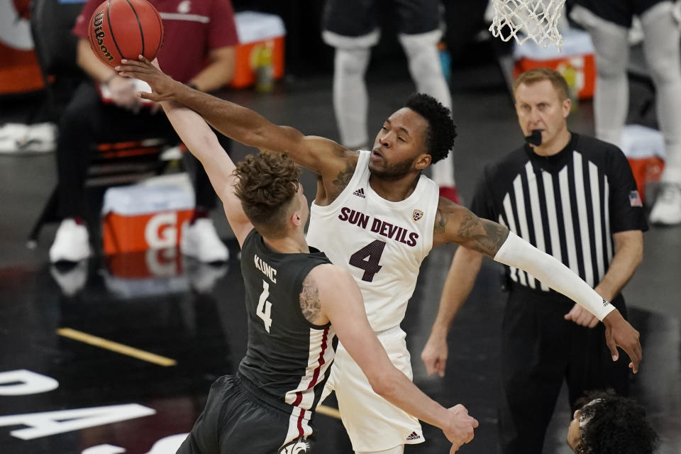Arizona State's Kimani Lawrence, right, blocks a shot by Washington State's Aljaz Kunc during the second half of an NCAA college basketball game in the first round of the Pac-12 men's tournament Wednesday, March 10, 2021, in Las Vegas. (AP Photo/John Locher)