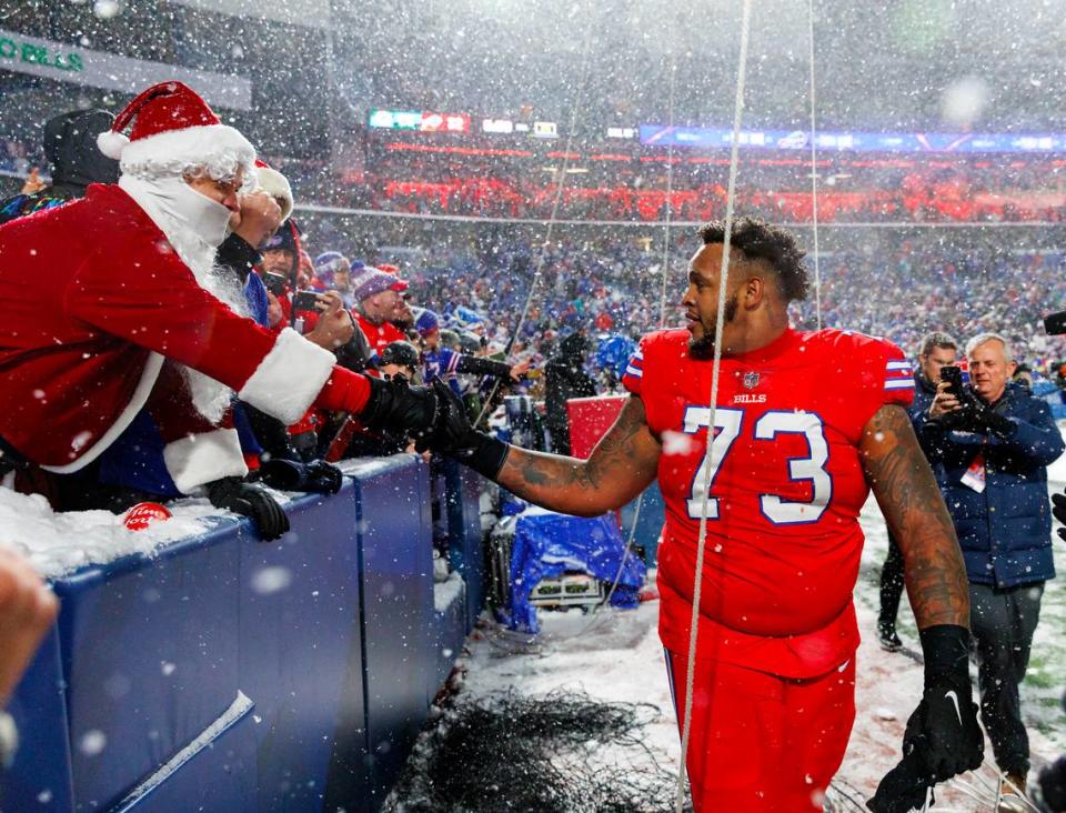 Buffalo Bills offensive tackle Dion Dawkins (73) greets fans after their 32-29 win over the Miami Dolphins during an NFL football game at Highmark Stadium on Saturday, December 17, 2022 in Orchard Park, New York.