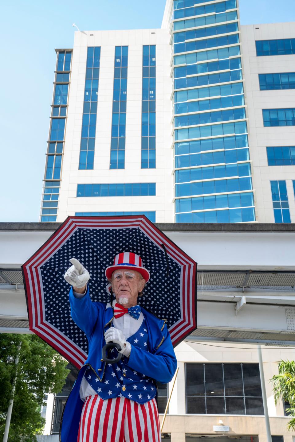 A man dressed as Uncle Sam stands outside the Wilkie D. Ferguson Jr. U.S. Courthouse before the arraignment of former President Donald Trump on Tuesday.