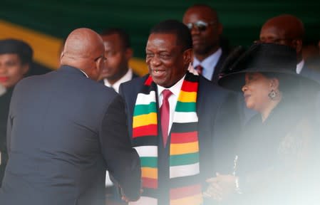 Zimbabwean President Mnangagwa welcomes former president of South Africa, Zuma ahead of the state funeral of Mugabe, at the national sports stadium in Harare