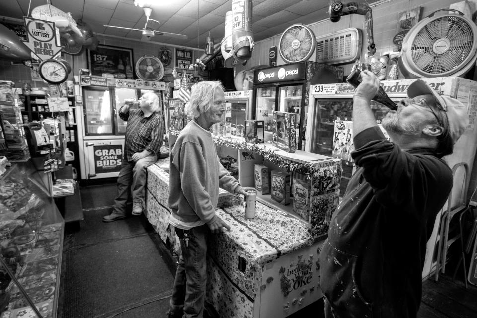 Tim Schnurr, right, took a drink of beer while talking to Tim Thorpe, center, and Billy Phelps drank an orange juice in the background, at Hauckâ€™s Handy Store. Oct. 19, 2018.