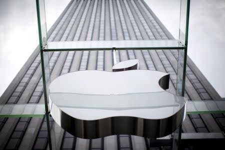 An Apple logo hangs above the entrance to the Apple store on 5th Avenue in the Manhattan borough of New York City, July 21, 2015. REUTERS/Mike Segar