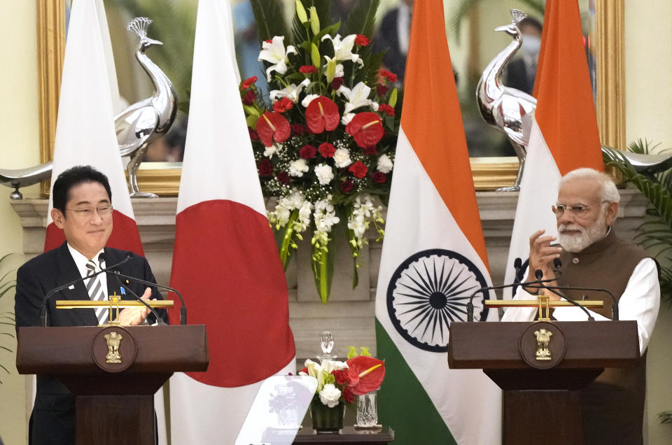 Japan’s Prime Minister Fumio Kishida, left and Indian Prime Minister Narendra Modi, applaud after making press statements following their meeting in New Delhi, India, Monday, March 20, 2023. (AP Photo/Manish Swarup)