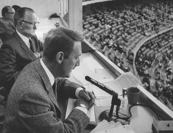 1967 file photo of Dodger announcer Vin Scully (foreground) with his announcing teamate Jerry Doggett. - Associated Press