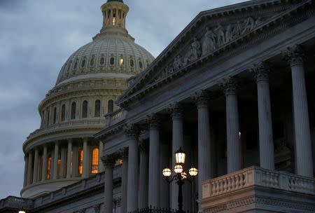 The U.S. Capitol building is lit at dusk ahead of planned votes on tax reform in Washington, U.S., December 18, 2017. REUTERS/Joshua Roberts