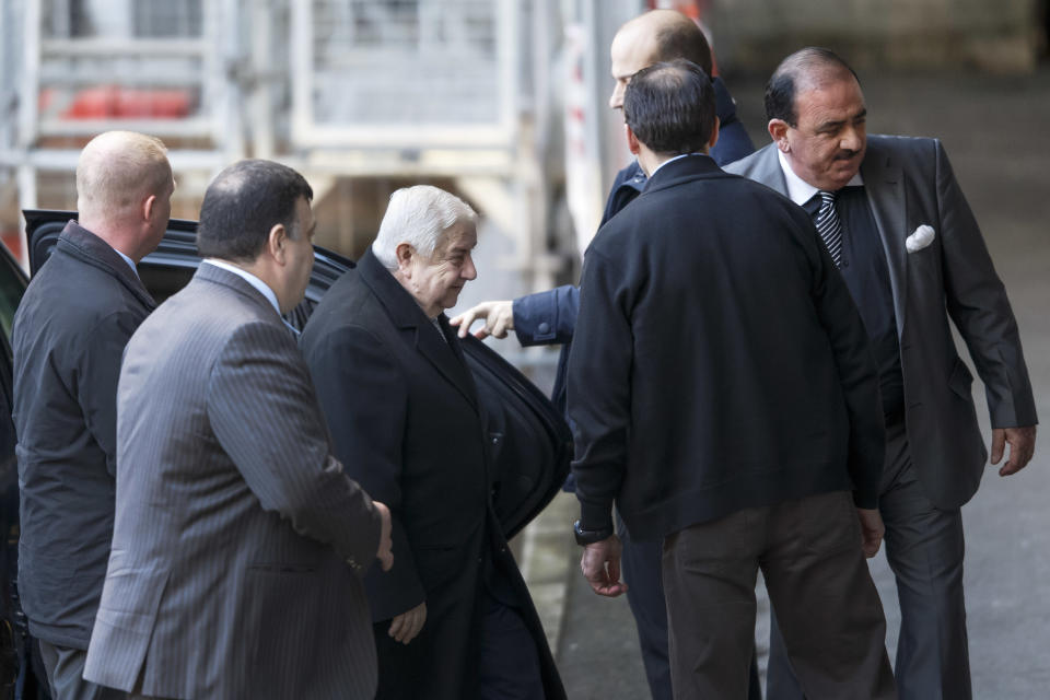 Syrian Foreign Minister Walid al-Mouallem, third left, arrives for the start of negotiations at the European headquarters of the United Nations, in Geneva, Switzerland, Friday, January 24, 2014. Al-Mouallem will meet UN-Arab League envoy for Syria Lakhdar Brahimi. (AP Photo/Keystone, Salvatore Di Nolfi)