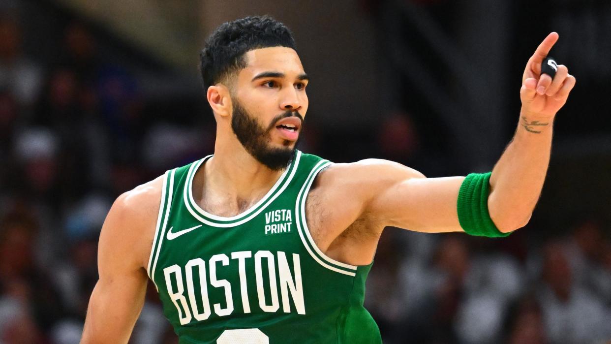 Boston Celtics star Jayson Tatum celebrates hitting a basket