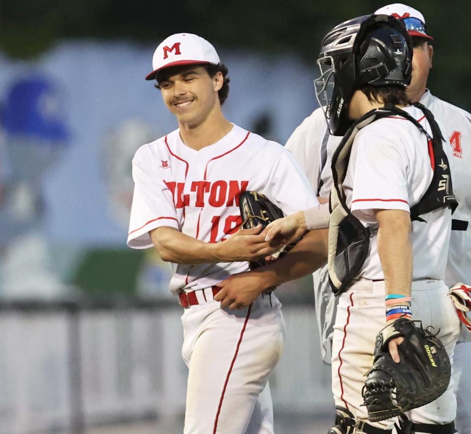 Milton starting pitcher Scott Longo is all smiles as he exits the game against Whitman-Hanson at Fraser Field in Lynn on Tuesday, June 13, 2023.