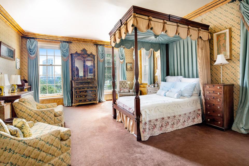 9) The master bedroom features a stunning canopy bed, water views, and a custom master bath.