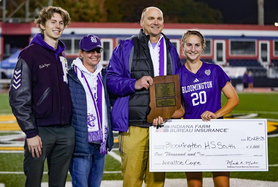 Bloomington South’s Annalise Coyne poses with her family after receiving the Mental Attitude award during the IHSAA girls’ soccer state championship match at Michael Carroll Track & Soccer Stadium in Indianapolis, Ind. on Saturday, Oct. 28, 2023.