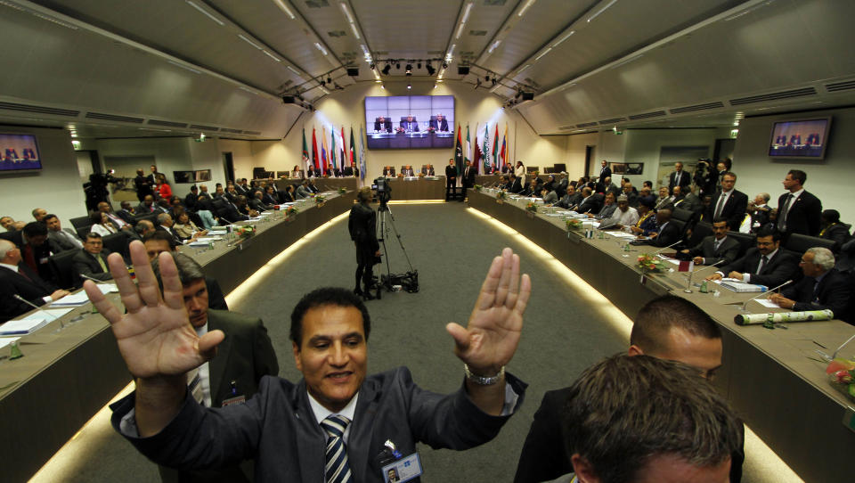 A security asks the media to leave the conference room prior to the start of a meeting of oil ministers of the Organization of the Petroleum Exporting countries, OPEC, at their headquarters in Vienna, Austria, on Thursday, June 14, 2012. The meeting of the 12 oil ministers of the OPEC focuses on price and production targets. (AP Photo/Ronald Zak)