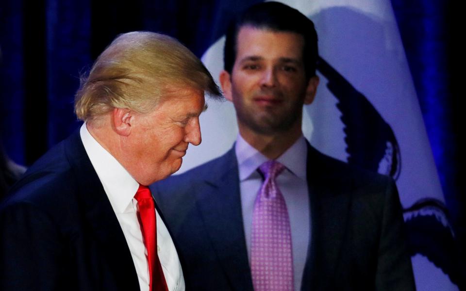 Donald Trump Jr watches his father leave the stage on the night of the Iowa Caucus, in February 2016 - Credit: Reuters