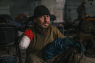 In this photo provided by Azov Special Forces Regiment of the Ukrainian National Guard Press Office, a Ukrainian soldier injured during fighting against Russian forces, poses for a photographer inside the Azovstal steel plant in Mariupol, Ukraine, May 10 2022. For nearly three months, Azovstal’s garrison clung on, refusing to be winkled out from the tunnels and bunkers under the ruins of the labyrinthine mill. A Ukrainian soldier-photographer documented the events and sent them to the world. Now he is a prisoner of the Russians. His photos are his legacy.(Dmytro Kozatsky/Azov Special Forces Regiment of the Ukrainian National Guard Press Office via AP)