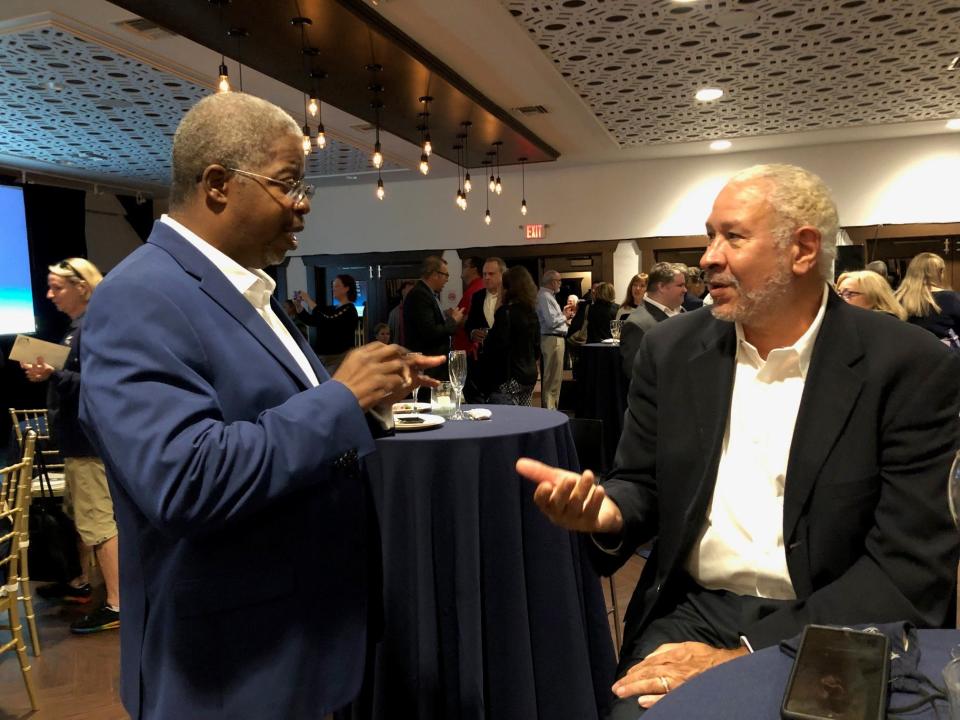 Brevard Zoo cabinet member Clarence Williams, left, talks with Fred Lynn of Lynn Leisure Development at the kickoff of the zoo's $100 million campaign to build an aquarium and conservation center on the shore of the Banana River.