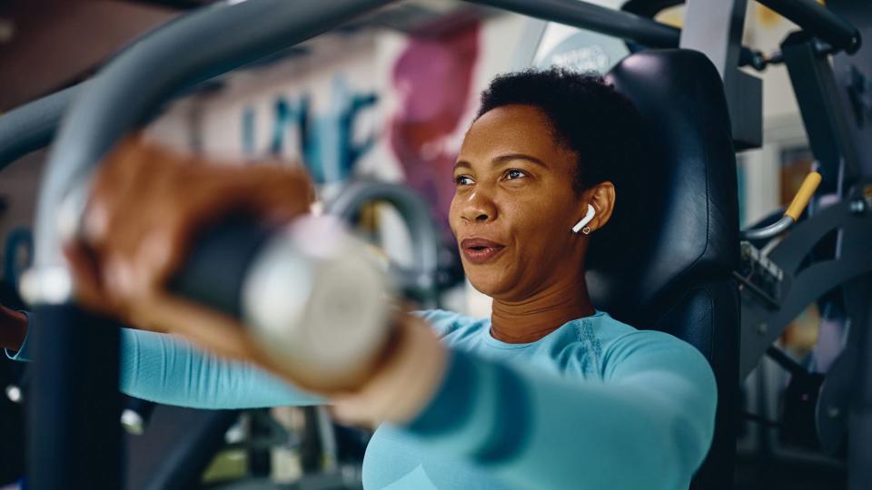 Woman using resistance machine at the gym